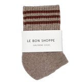Pair of brown striped socks with a white label on a white background