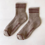 Pair of brown socks with striped pattern on a white background