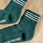 Green socks with white stripes on kraft paper background