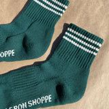 Green socks with white stripes on kraft paper background