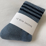 Blue shoes with navy stripes in white Le Bon Shoppe packaging on white background