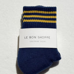 Pair of blue socks with yellow stripes and a visible brand label on a light gray background