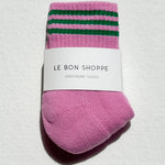 Pink socks with green stripes on a white background, labeled 'Le Bon Shoppe'.
