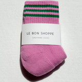 Pink socks with green stripes on a white background, labeled 'Le Bon Shoppe'.