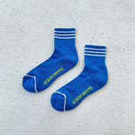 Blue socks with white stripes on light grey backgound