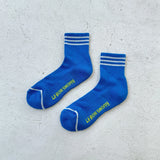 Blue socks with white stripes on light grey backgound