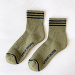 Pair of green socks with black stripes and 'LE BON SHOPPE' branding on a white background