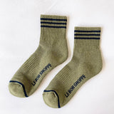 Pair of green socks with black stripes and 'LE BON SHOPPE' branding on a white background
