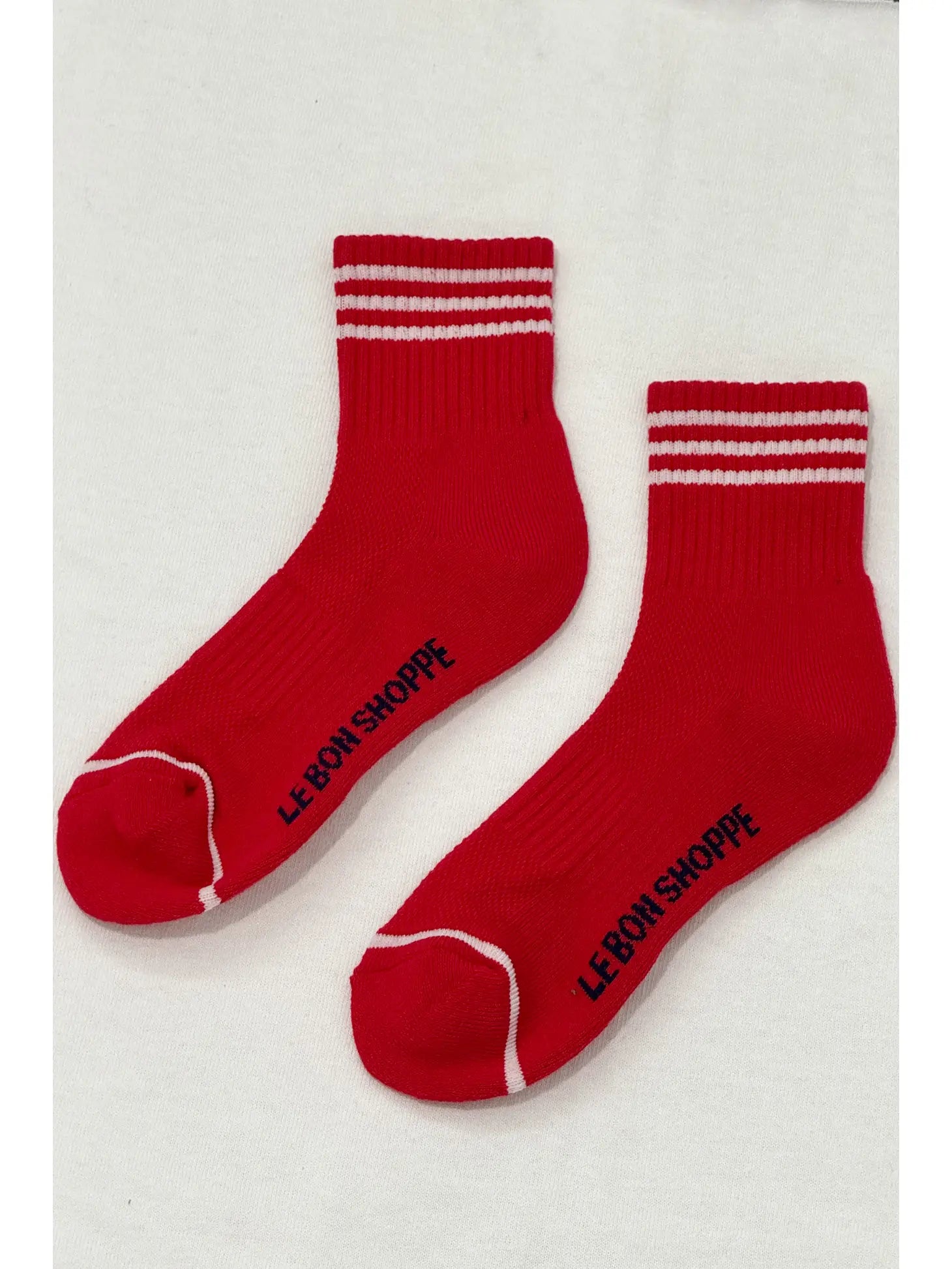 Red socks with white stripes on white background