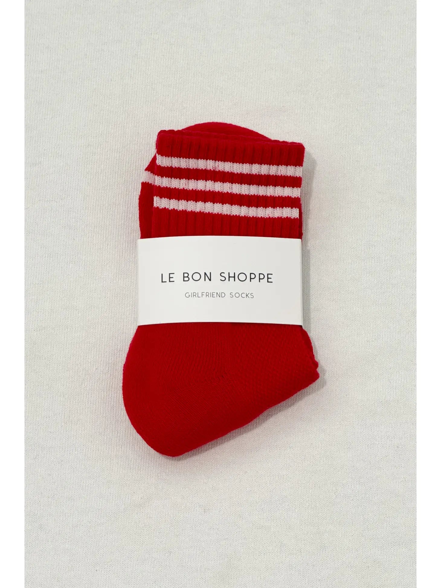 Red socks with white stripes in white Le Bon Shoppe packaging