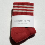 Red and white striped socks with a label on a light gray background