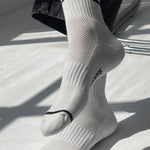 White socks with black stripes and text on a light background