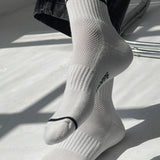 White socks with black stripes and text on a light background