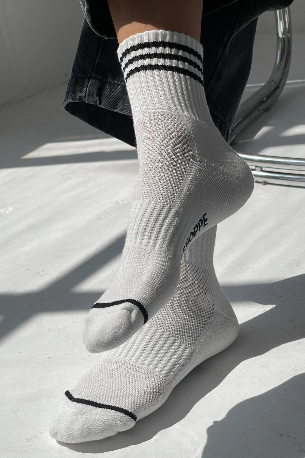 White socks with black stripes and text on a light background