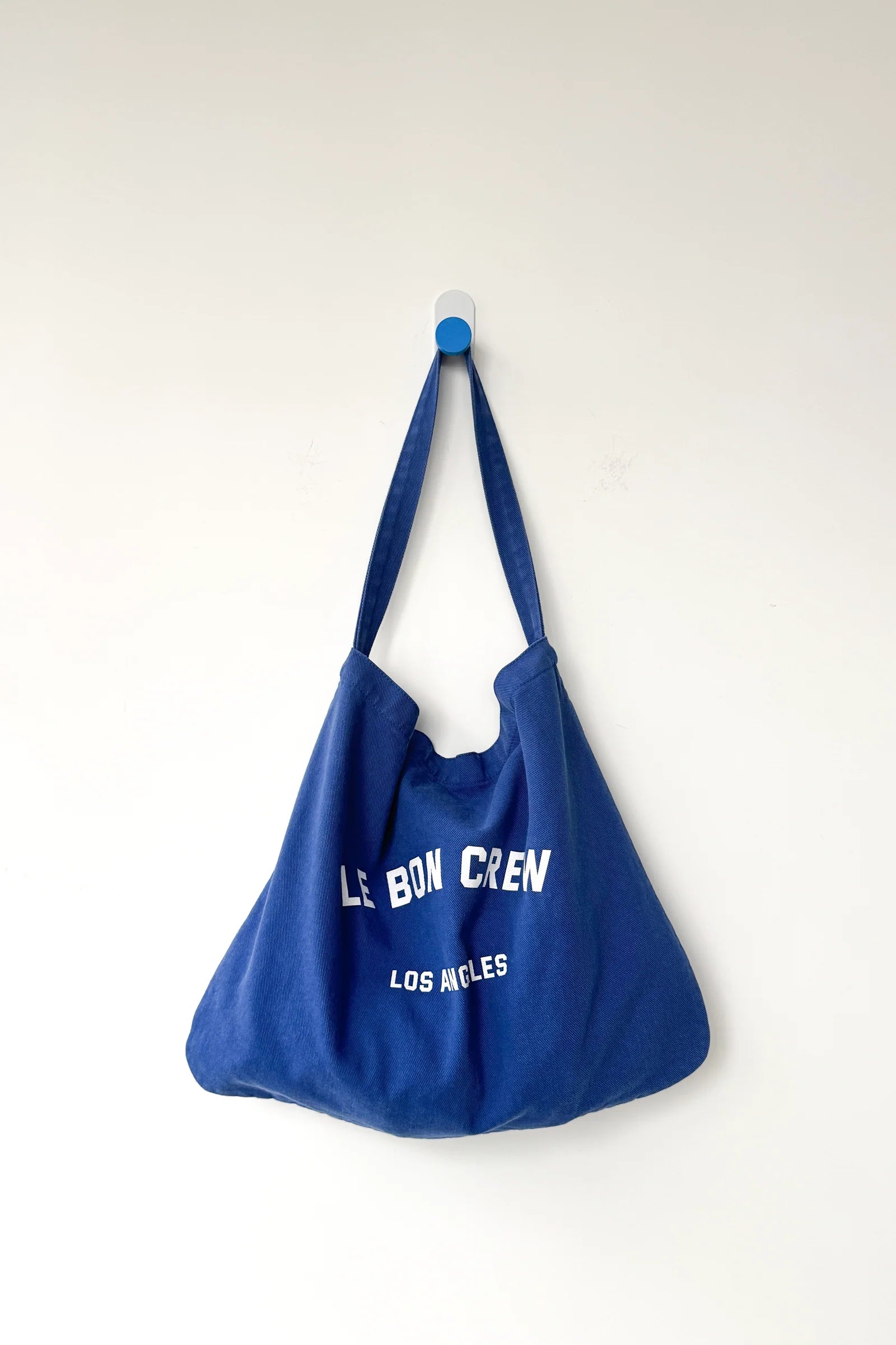 Blue tote bag with text on a white background