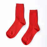 Pair of red socks on a white background