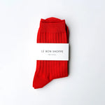 Red socks with a white label on a white background