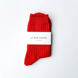 Red socks with a white label on a white background