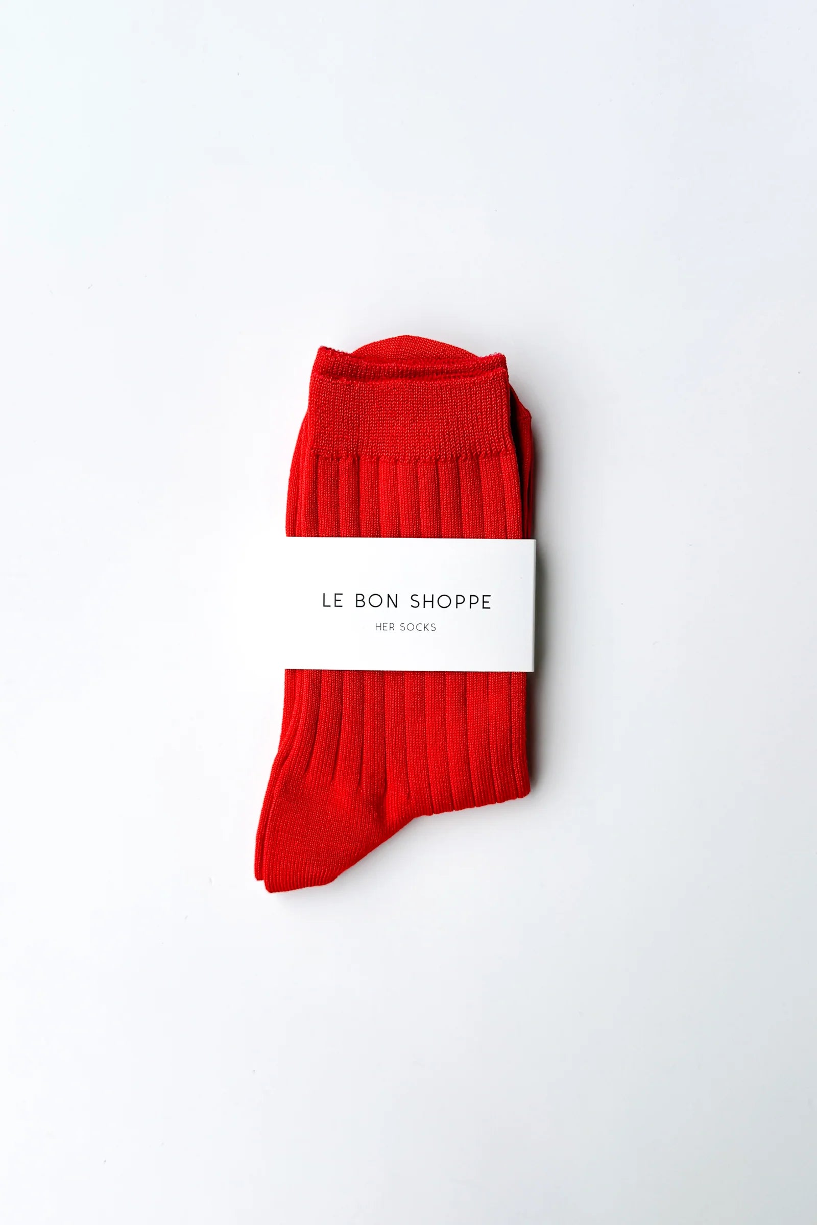 Red socks with a white label on a white background