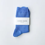 Blue socks with a white label on a light gray background