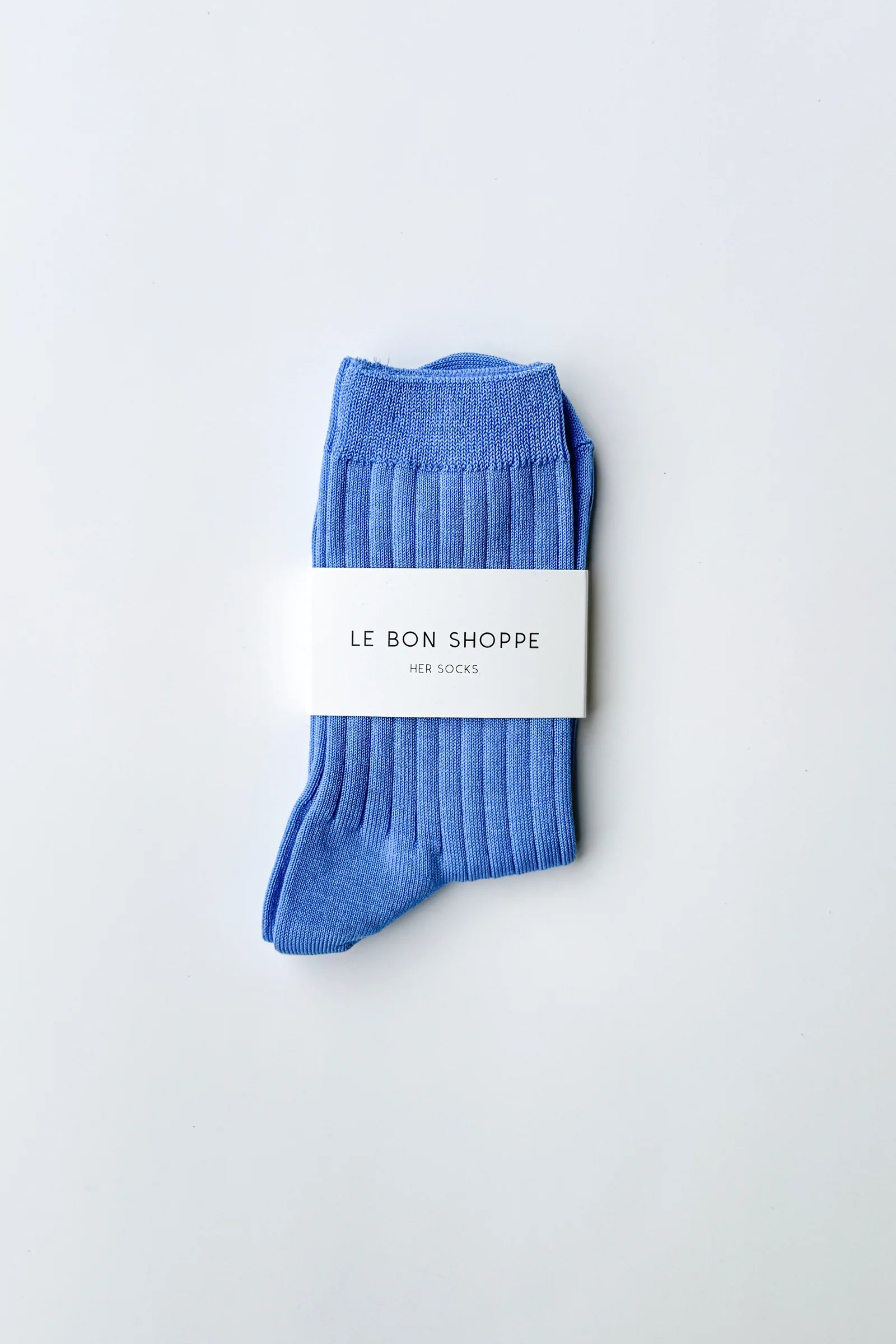 Blue socks with a white label on a light gray background