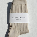 Beige socks with a 'Le Bon Shoppe' label on a light gray background
