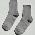 Pair of gray socks on a light gray background