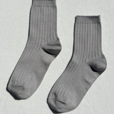 Pair of gray socks on a light gray background
