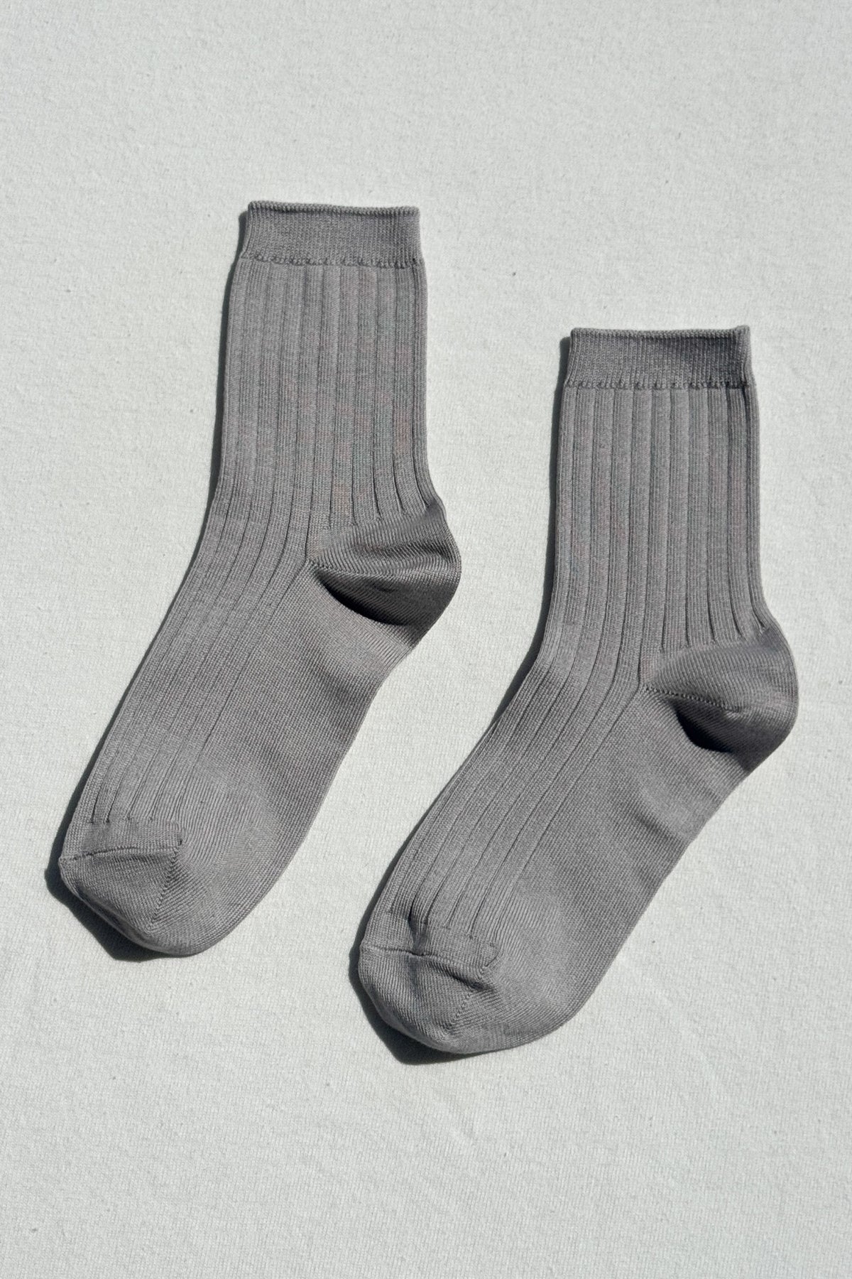 Pair of gray socks on a light gray background