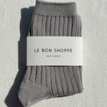 Gray socks with a 'Le Bon Shoppe' label on a light gray background