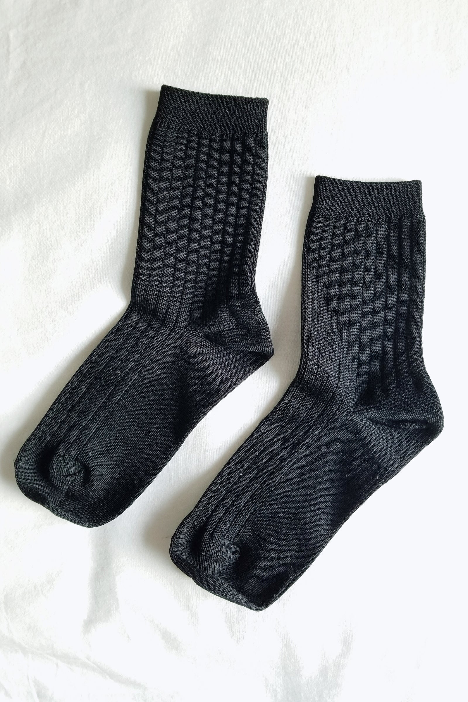 Pair of black socks on a white background