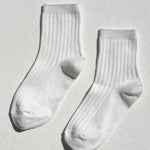 Pair of white socks on a light gray background