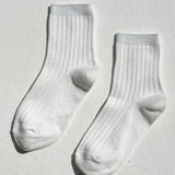Pair of white socks on a light gray background