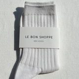Gray socks with a 'Le Bon Shoppe' label on a light gray background