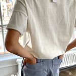 Back of person wearing white tee shirt and jeans