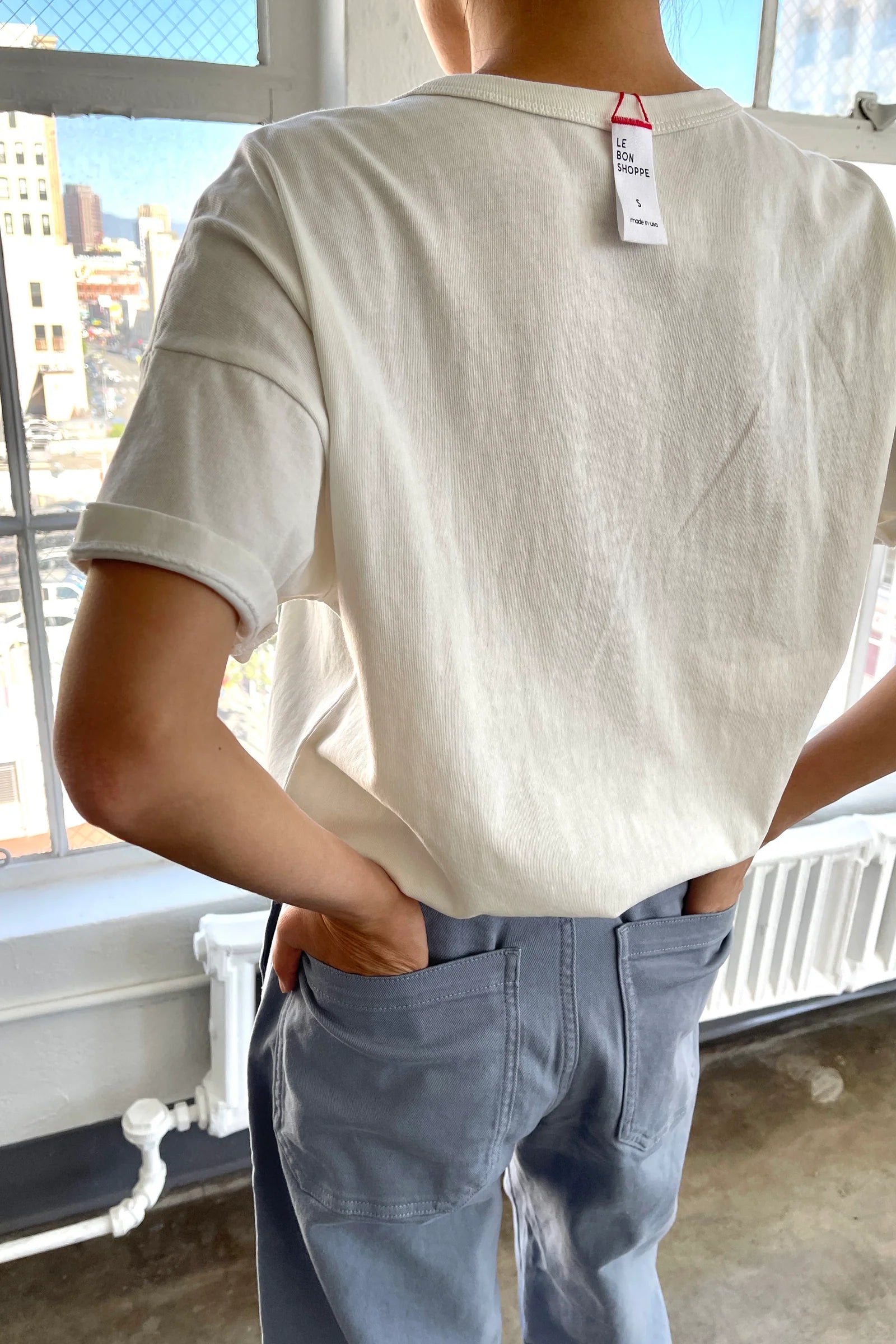 Back of person wearing white tee shirt and jeans