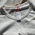 white tee shirt laying on white background