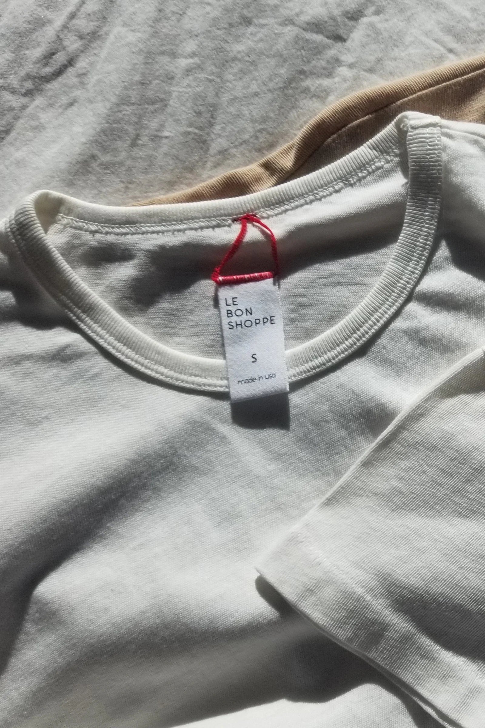 white tee shirt laying on white background