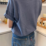 back of person wearing navy tee shirt and blue jeans