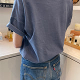back of person wearing navy tee shirt and blue jeans