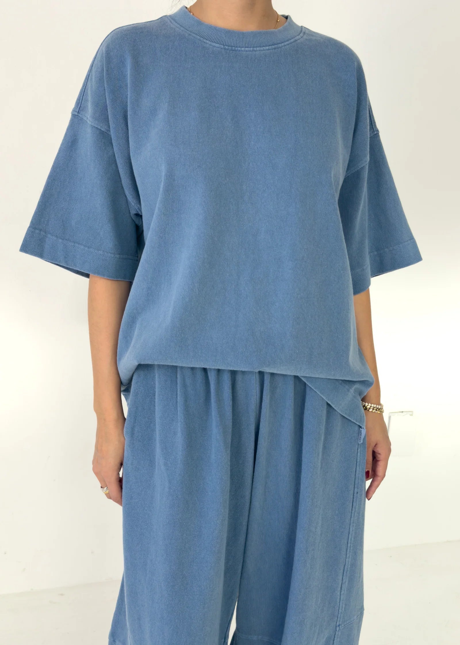 Person wearing a blue outfit on a white background