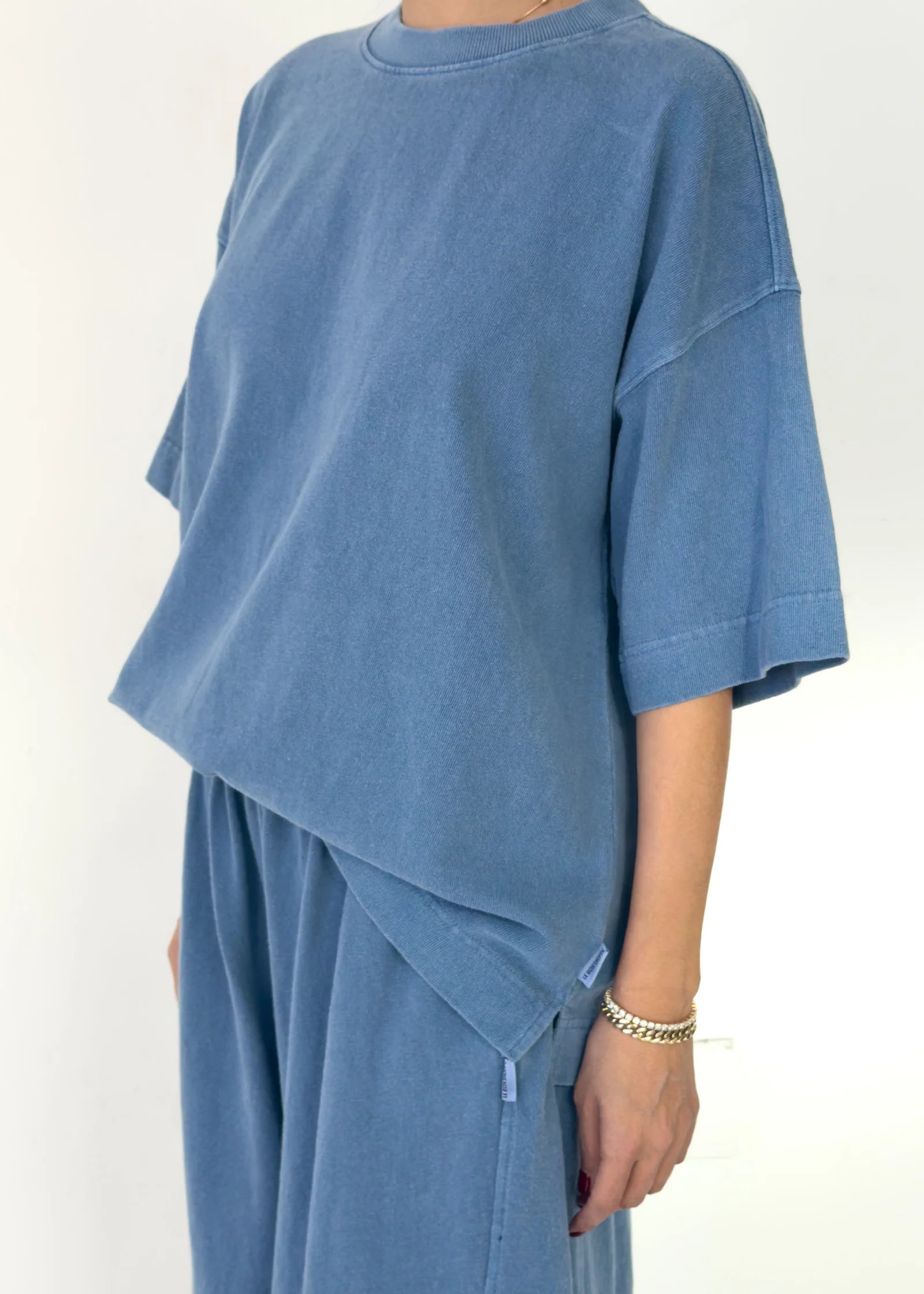 Person wearing a blue outfit on a white background