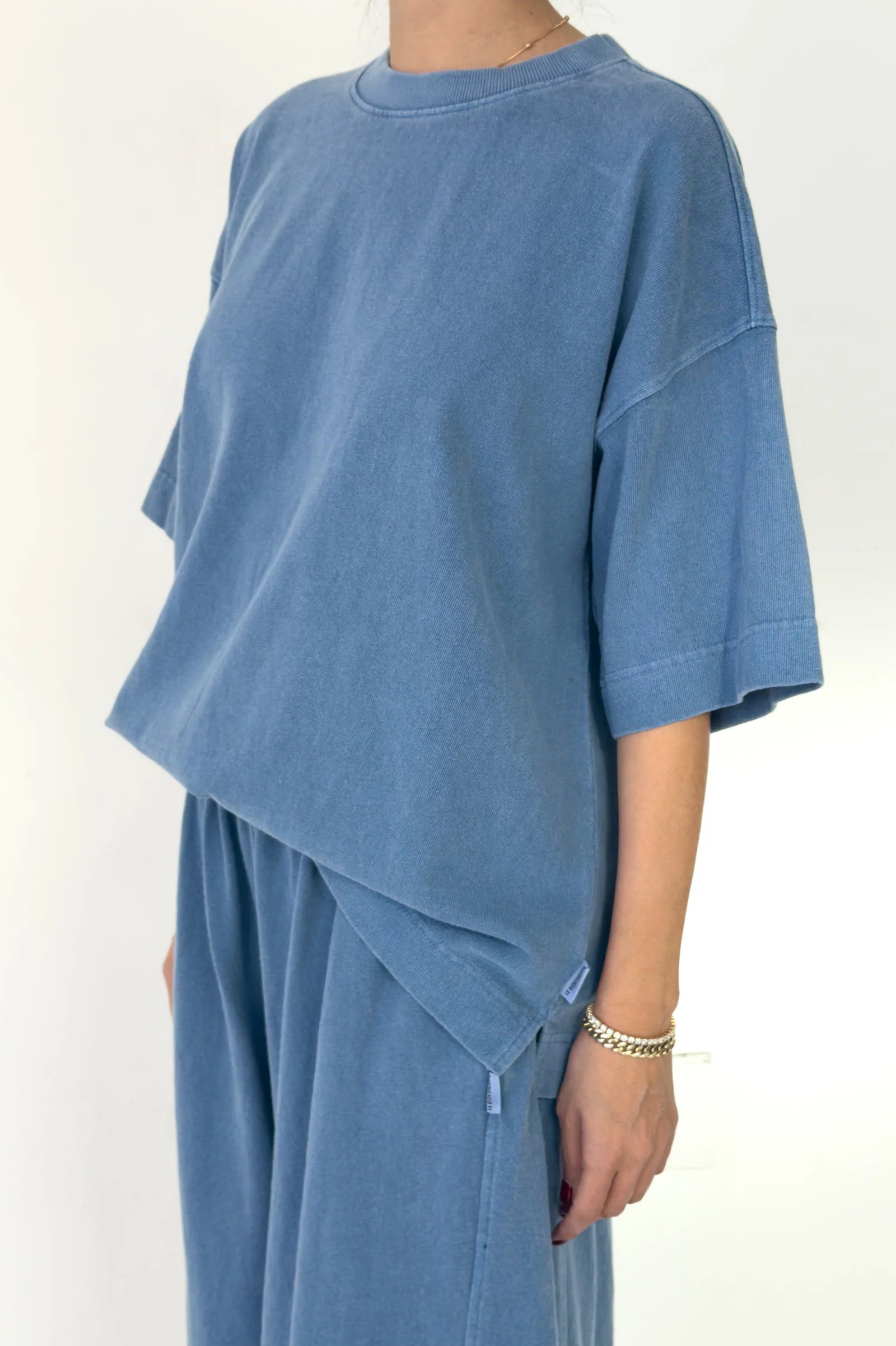 Person wearing a blue outfit on a white background