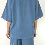 Blue outfit with a t-shirt and pants on a white background