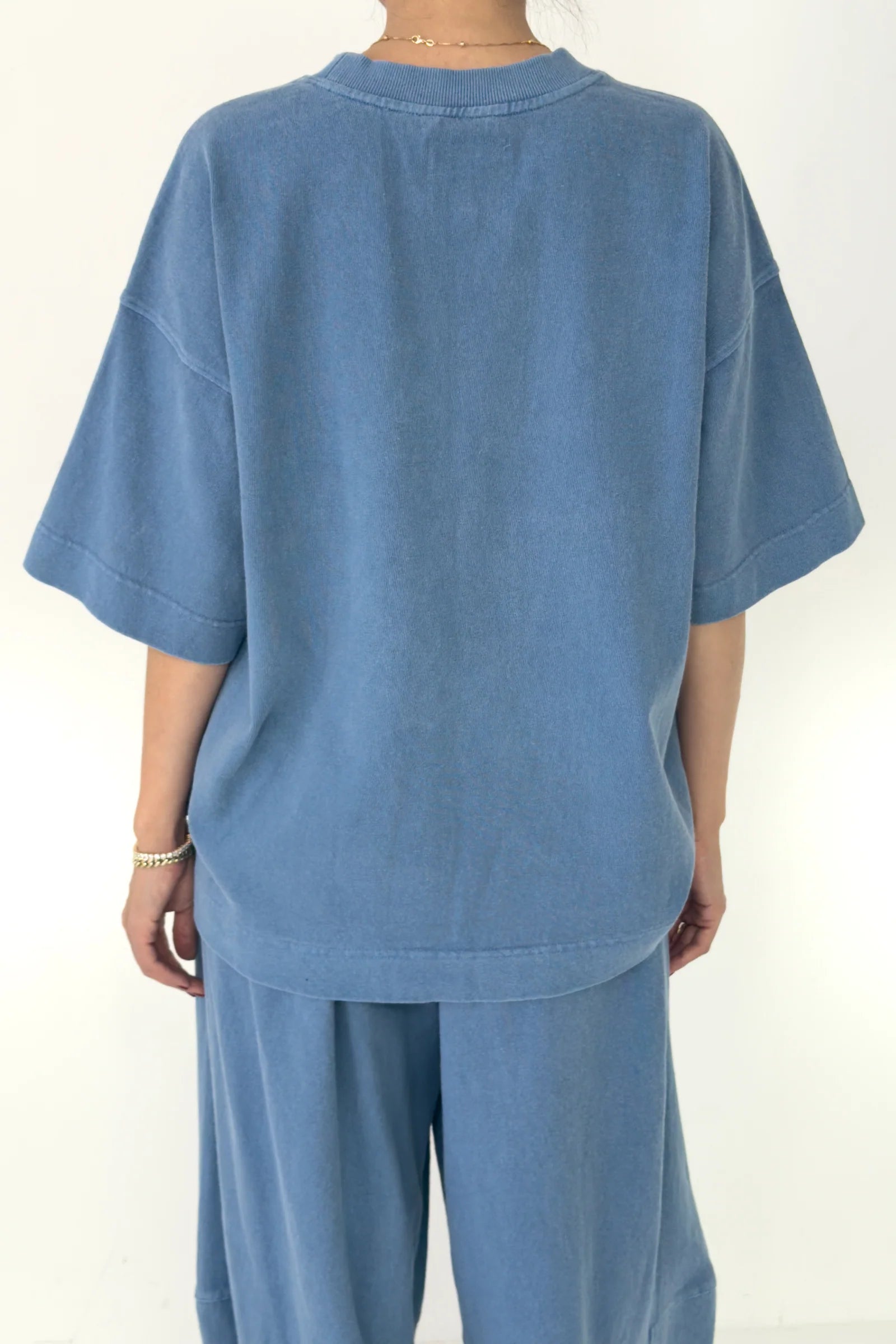Blue outfit with a t-shirt and pants on a white background
