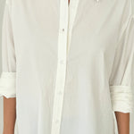 White button-up shirt worn by a person on a plain background