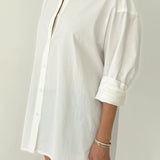 White shirt worn by a person on a plain background