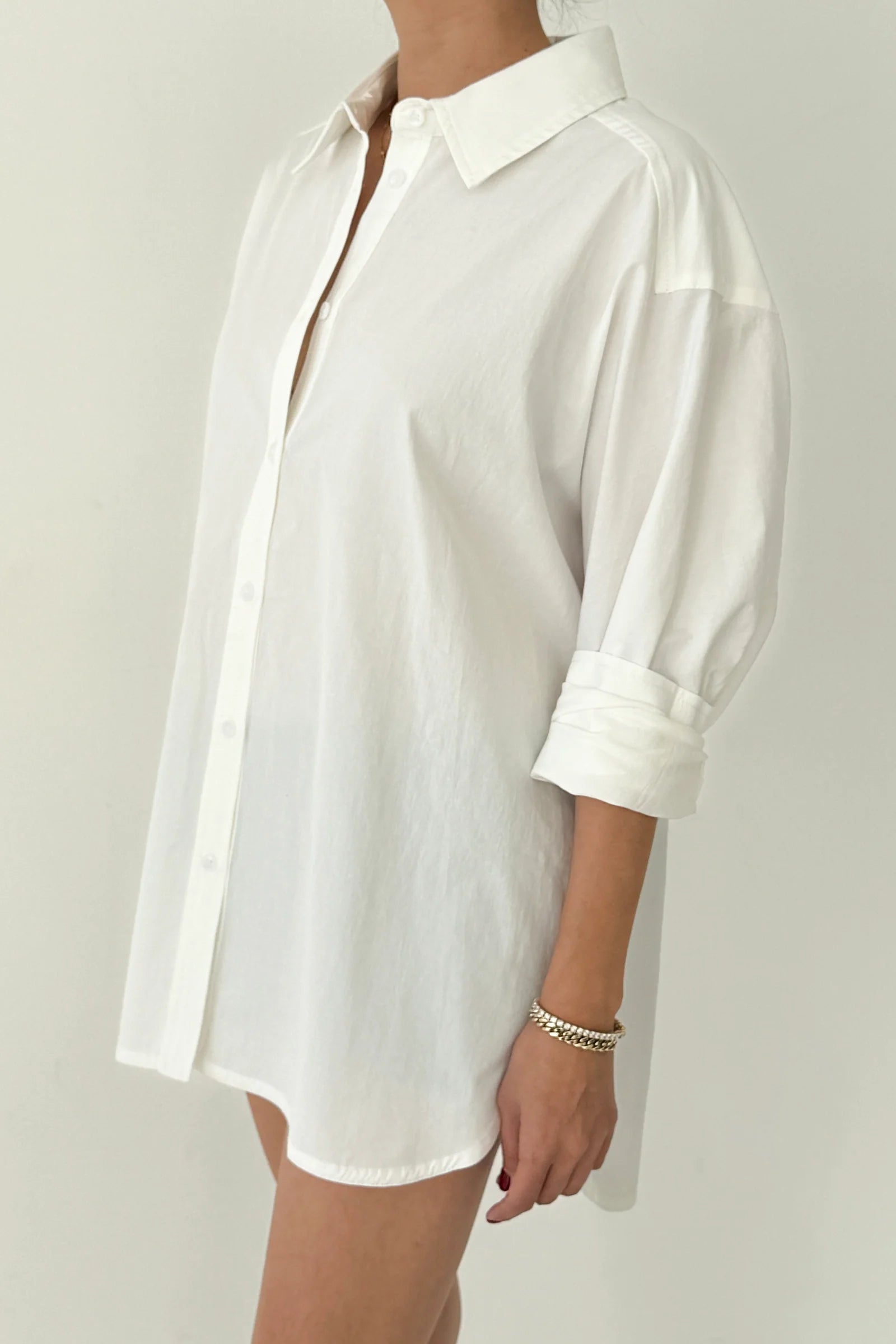 White shirt worn by a person on a plain background