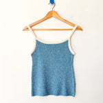 Blue tank top on a wooden hanger against a white background