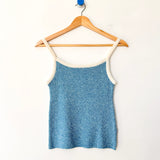Blue tank top on a wooden hanger against a white background